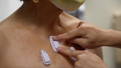 A health care worker places the wearable devices across a patient's chest to capture sounds throughout the lungs that are associated with breathing. Photo courtesy of Northwestern University.
